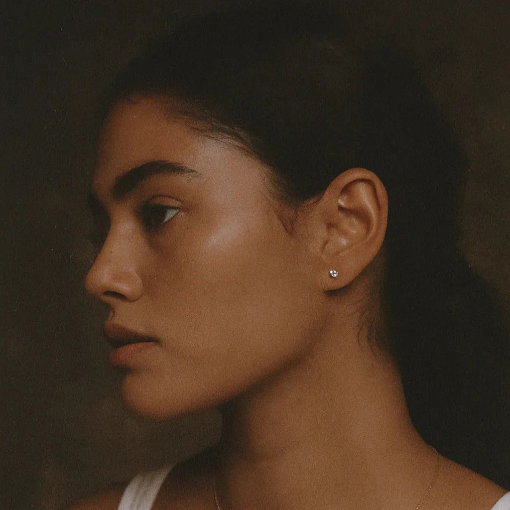 Rari Model wearing diamond stud earrings in profile view