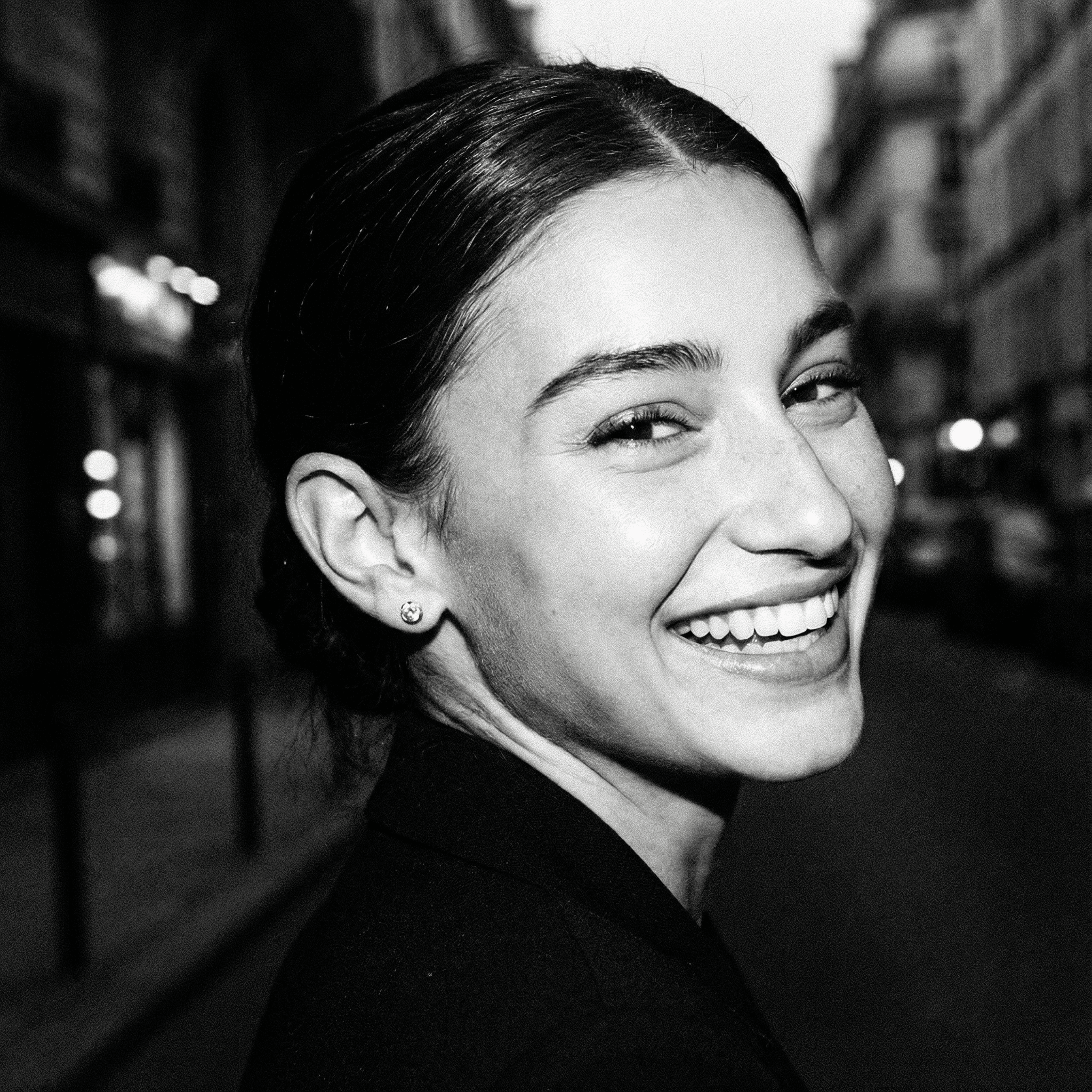 Close-up of woman smiling with Rari diamond stud earrings